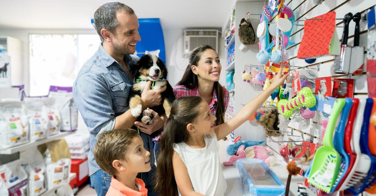 family with their dog at pet store
